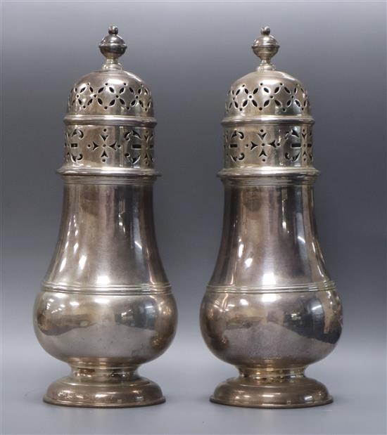 A pair of George V silver baluster castors, London 1933, retailed by Tessiers, 20cm, 17oz